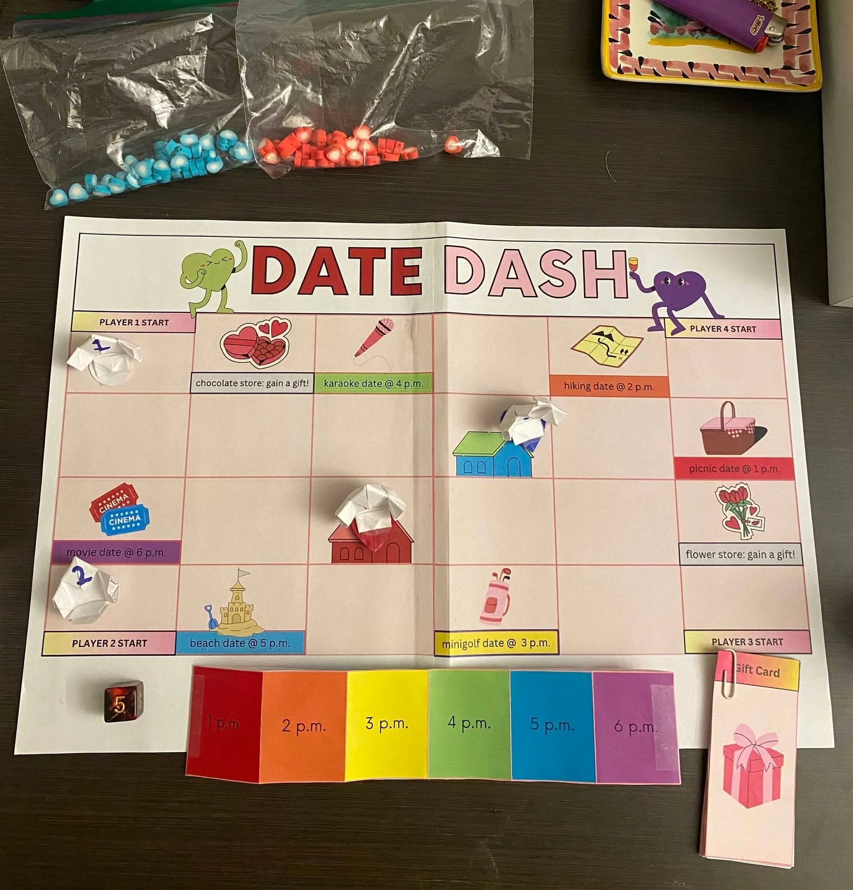 The full Date Dash set: board with pawns, time belt, gift cards, die and bags of red and blue hearts