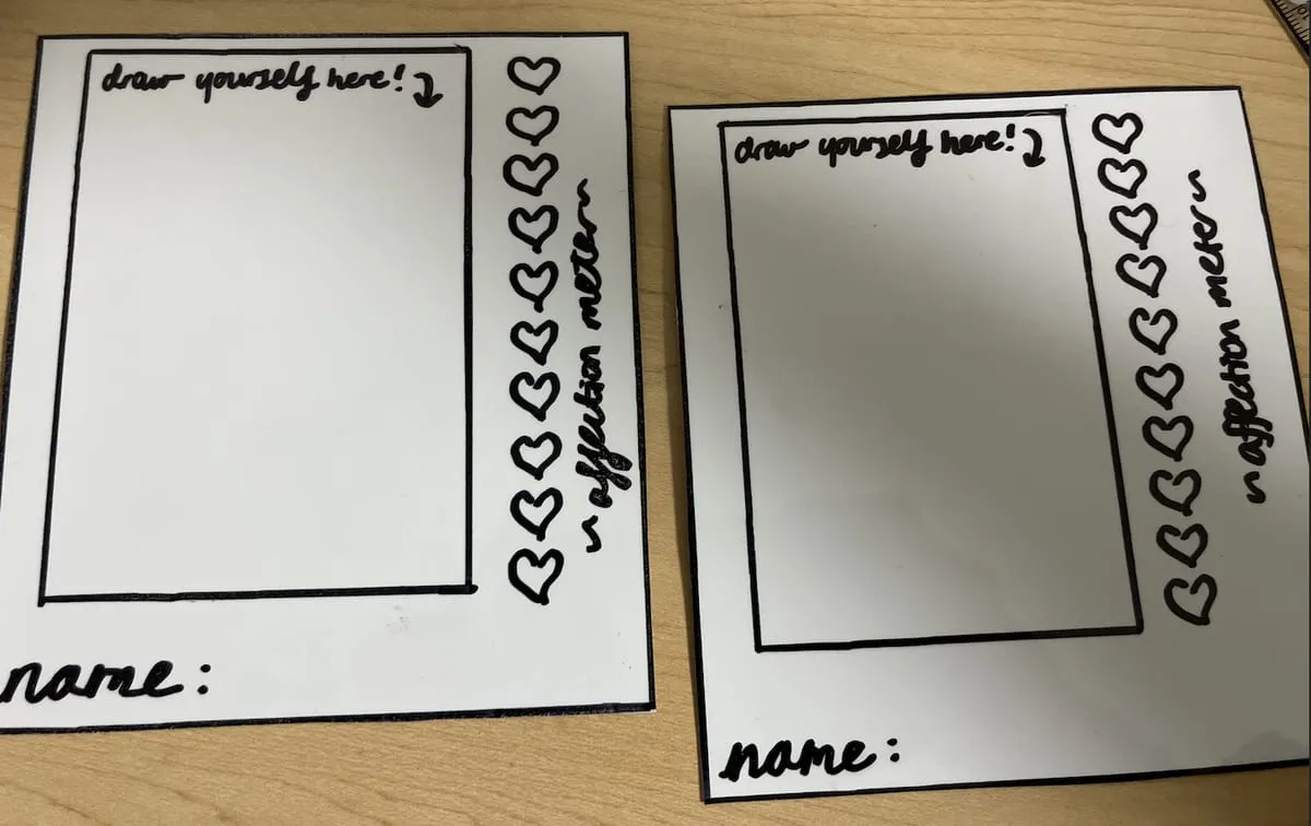 Two dry-erase profile cards with a "draw yourself here" box and a column of hearts for the affection meter